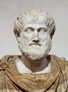 Marble bust of Aristotle with a curly beard and a draped alabaster mantle