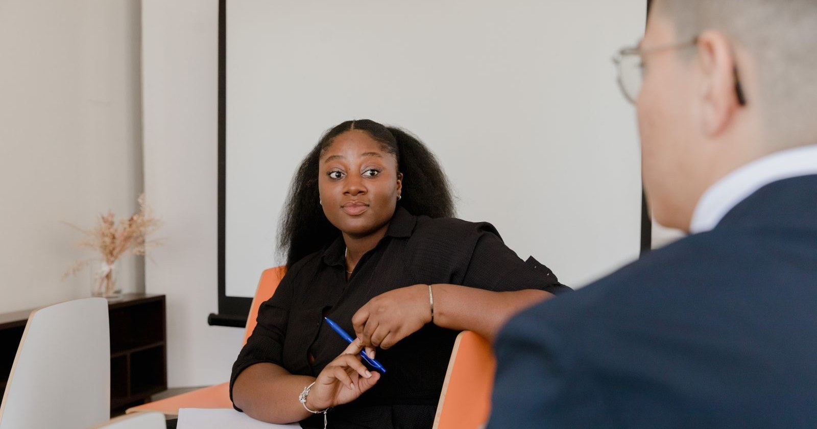 A woman listening attentively to a colleague during a meeting